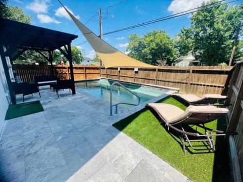 a swimming pool with chairs and a slide at Relax in HTX POOL,15ppl,4br,4b in Houston