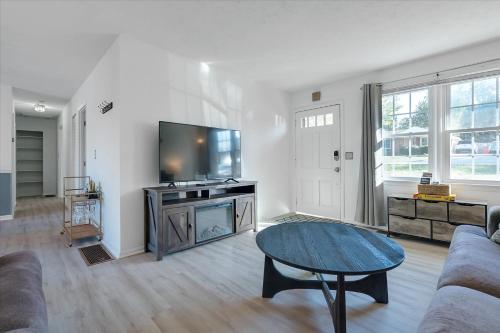 a living room with a flat screen tv and a table at The Kentucky Bluegrass Retreat in Frankfort