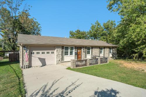 a small stone house with a garage at The Kentucky Bluegrass Retreat in Frankfort