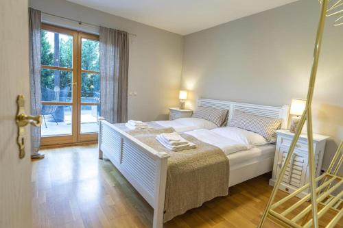 a bedroom with a white bed and a large window at Landvilla Diebach in Diebach