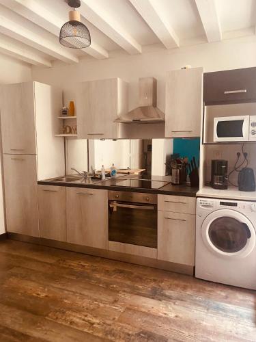 une cuisine avec un lave-linge et un lave-linge dans l'établissement Au porte du château, à Chinon