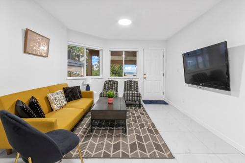 a living room with a yellow couch and chairs at Pristine 3 Beds 2 Washroom Guest Suite in Surrey