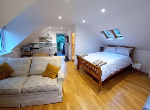 a large bedroom with a bed and a couch at Oak Loft in Lyme Regis