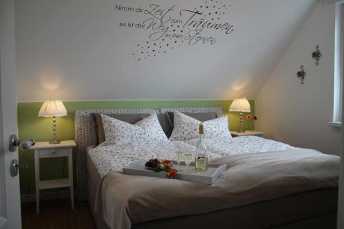 a bedroom with a bed with a tray of fruit on it at Ferienwohnung Morgensonne in Born