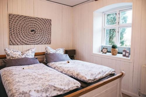 a bedroom with two beds and a window at Ferienhaus NATURlich Wassermuhle in Kappeln