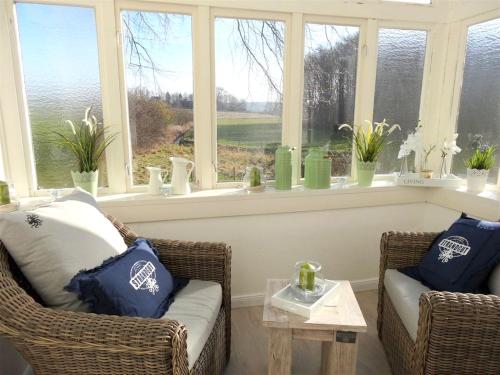 a living room with two chairs and a window at Ferienhaus NATURlich Wassermuhle in Kappeln