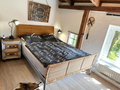a bedroom with a bed and a window at Ferienhaus NATURlich Wassermuhle in Kappeln