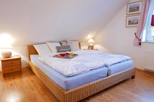 a bedroom with a bed with a tray of food on it at Apartments Kirsebek in Kappeln