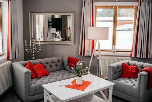a living room with two couches and a table at Ferienhaus Kleiner Onkel in Grödersby