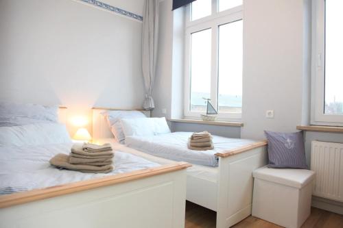 a bedroom with two beds and a window at Amanda in Kappeln