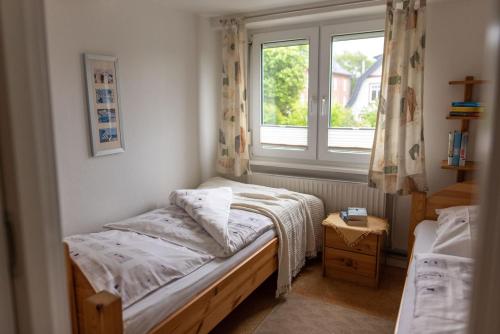 a small bedroom with a bed and a window at Amrum in Kappeln