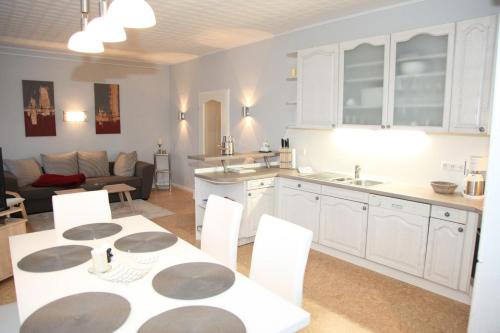 a kitchen and living room with a table and chairs at Seestern in Kappeln