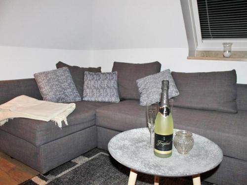 a bottle of wine on a table in a living room at Strandkorb in Kappeln