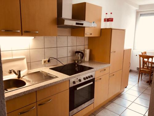a kitchen with a sink and a stove top oven at Quiet beautiful apartment in Tuttlingen