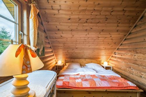 a bedroom with a bed in a wooden cabin at Mein Blockhaus in Hasselberg