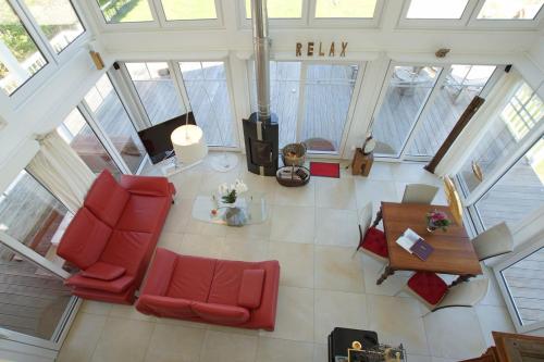 an overhead view of a living room with red furniture at Thor's Schleilounge in Olpenitz