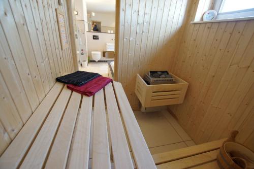 a sauna with a bench in the middle of a room at Thor's Schleilounge in Olpenitz
