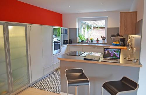 a kitchen with a counter with a laptop on it at Schleiglanz in Ulsnis