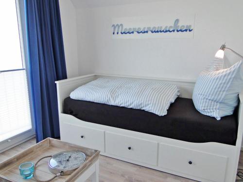a bedroom with a bed with a drawer and a table at Flow in Kappeln