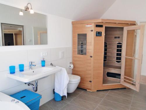 a bathroom with a sink and a toilet and a shower at Flow in Kappeln