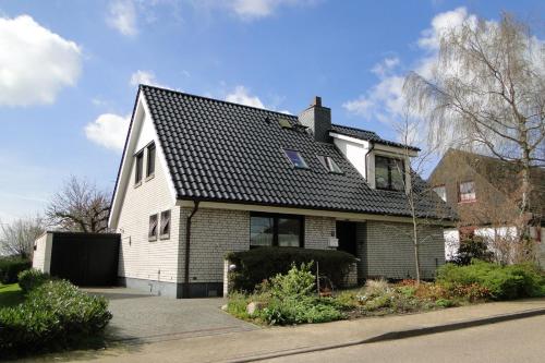 a white house with a black roof at Vincent in Kappeln