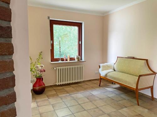 a living room with a chair and a window at Stadtoase in Süderbrarup