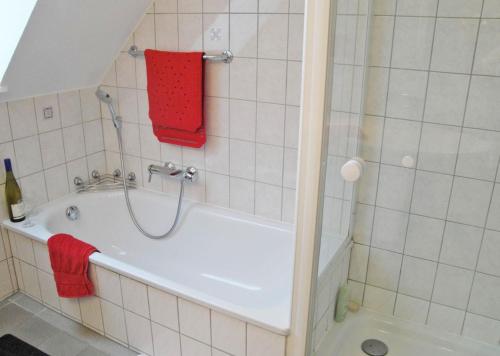 a bathroom with a bath tub with a red towel at Vincent in Kappeln