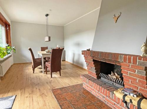 a living room with a brick fireplace and a table at Stadtoase in Süderbrarup