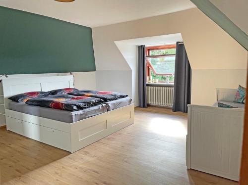 1 dormitorio con cama y ventana grande en Stadtoase, en Süderbrarup