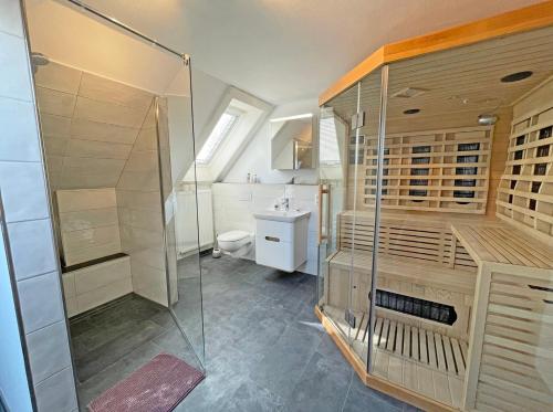 a bathroom with a shower and a toilet and a sink at Stadtoase in Süderbrarup