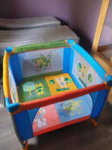 a toy crib with books on it in a bedroom at Face Of North in Gratangen