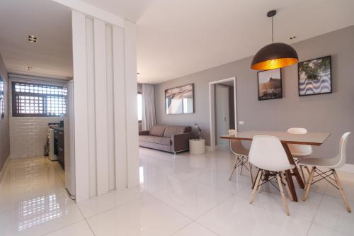 a dining room and living room with a table and chairs at Apartment Ocean View II in Rio de Janeiro