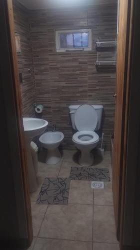 a bathroom with a toilet and a sink at Hospedaje Michay in Ushuaia