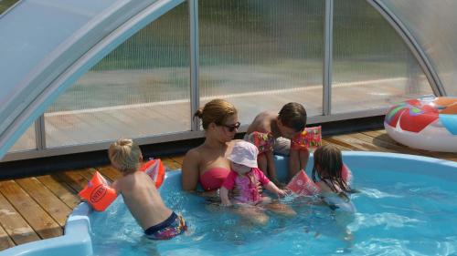 a group of people in a swimming pool at Nordanå Gård in Strö