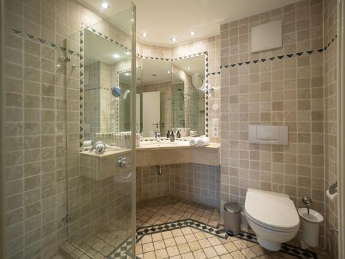 a bathroom with a shower and a toilet and a sink at Ferienwohnung 561 in der Villa Gudrun in Binz