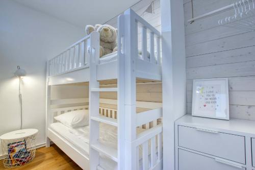 a white bunk bed in a childs bedroom at Landhaus am Ufer - Wohnung 3 in Heiligenhafen
