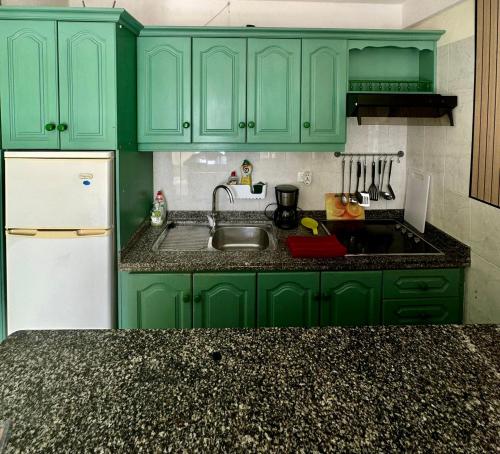 a green kitchen with a sink and a refrigerator at Apartment for 4 person! Viña del mar in Playa de las Americas