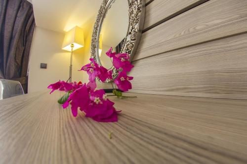 a bunch of pink flowers sitting on top of a table at S3 Seahorse Beach Club in Oludeniz