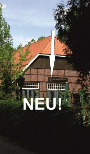 a house with a clock on the front of it at Ammerland 2 in Bad Zwischenahn