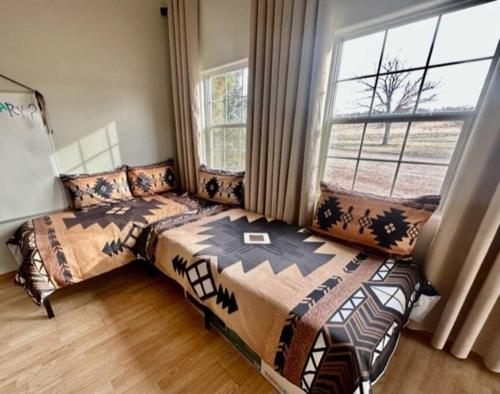 a bedroom with two beds and a window at River View Ranch 