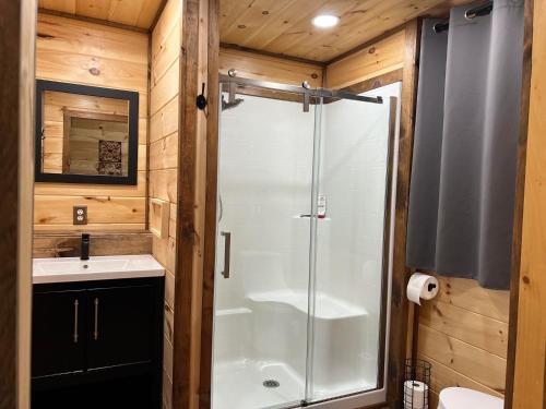 a bathroom with a shower and a sink at Riverview Escape - Cabins on the Ohio River 