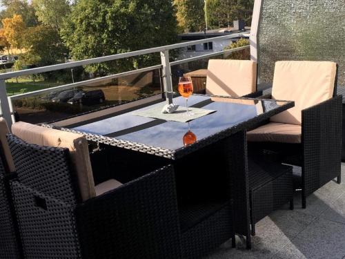 a table with a glass of wine on a balcony at Bellevue Nr. 35 in Scharbeutz
