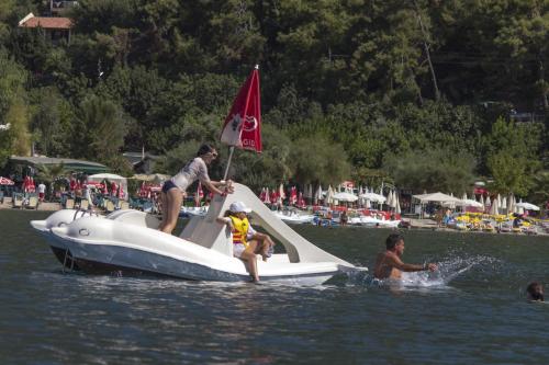 a group of people on a boat in the water at S3 Seahorse Beach Club in Oludeniz