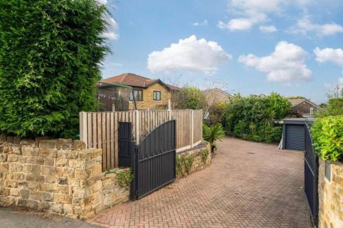 a fence with a gate in front of a house at Frank lane in Dewsbury