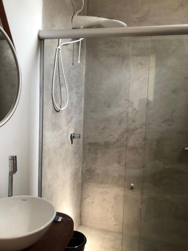 a bathroom with a shower and a sink at Villa Mendonza in Cruz