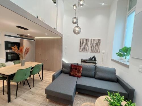 a living room with a couch and a table at Zeus Design Loft Apartments Braunhirschen in Vienna