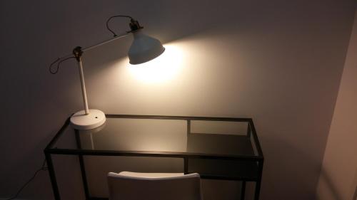 a desk with a lamp and a chair in a room at Apartments Top Center in Zagreb