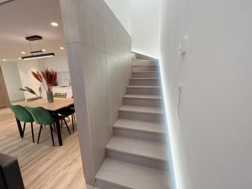 a stairway leading to a dining room with a table at Zeus Design Loft Apartments Braunhirschen in Vienna