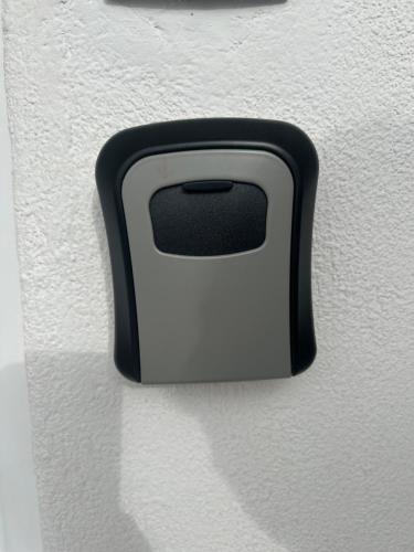 a black and white handle on a white wall at Catch n relax in Kalabaka