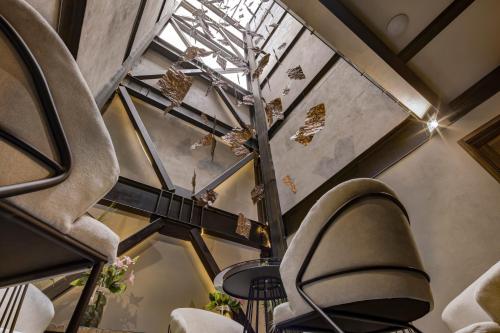 a room with chairs and a glass ceiling at MX Grand Suites in Mexico City